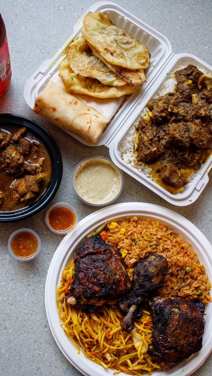 An appetizing assortment of traditional African foods including rice, meats, and sauces on a table.